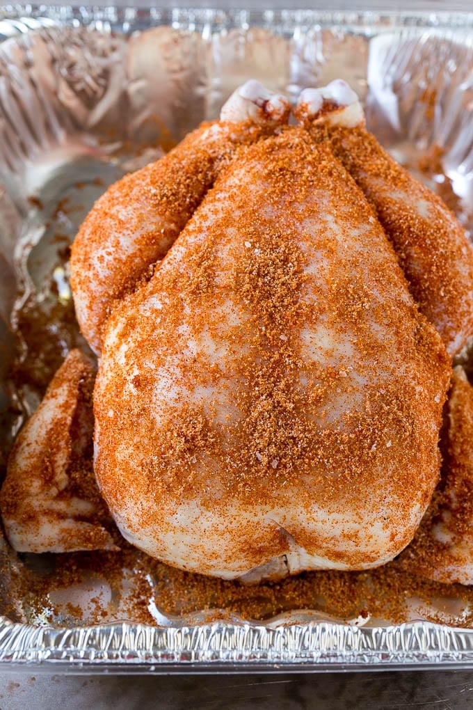 Smoked Chicken Recipe | Whole Smoked Chicken | BBQ Chicken #chicken #smoker #BBQ #dinner #edsug #glutenfree #lowcarb A raw bird is coated with homemade spice rub in a roasting pan.