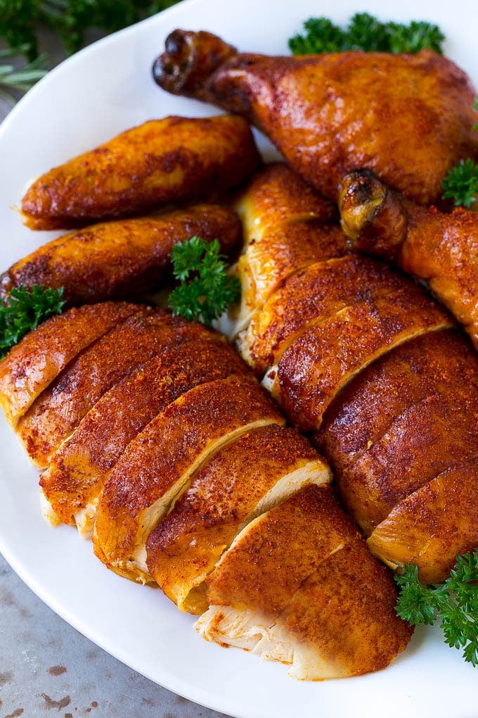 Smoked Chicken Recipe | Whole Smoked Chicken | BBQ Chicken #chicken #smoker #BBQ #dinner #edsug #glutenfree #lowcarb Carved smoked chicken including drumsticks, wings and chicken breasts on a serving platter.