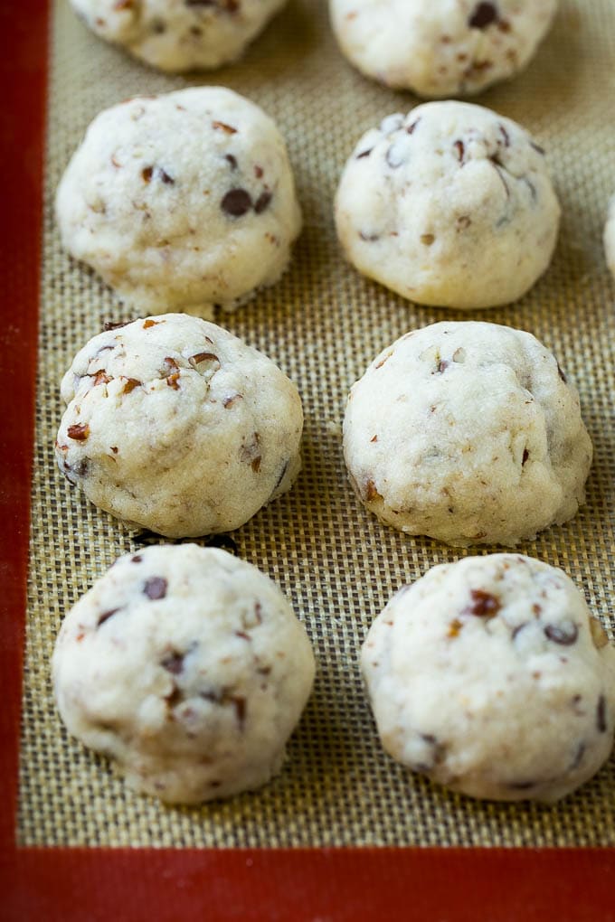 Snowball Cookies Recipe | Mexican Wedding Cookies | Russian Tea Cakes #cookies #pecan #chocolate #baking #dessert #christmas #edsug Baked snowball cookies on a sheet pan.