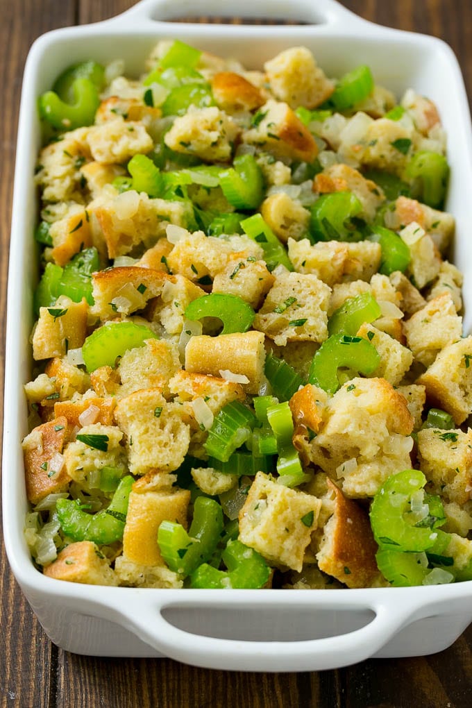 Turkey Stuffing Recipe | Thanksgiving Stuffing | Classic Stuffing #thanksgiving #stuffing #sidedish #fall #edsug Uncooked holiday stuffing in a baking dish.