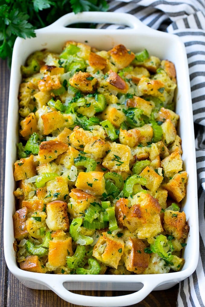 Turkey Stuffing Recipe | Thanksgiving Stuffing | Classic Stuffing #thanksgiving #stuffing #sidedish #fall #edsug Baked turkey stuffing in a dish topped with fresh parsley.