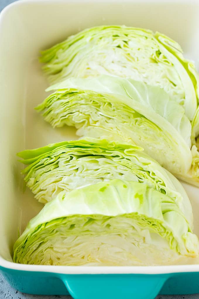 Braised Cabbage Recipe | Easy Cabbage Recipe #cabbage #lowcarb #keto #carrots #veggies #vegetarian #dinner #edsug Wedges of cabbage in a baking dish.