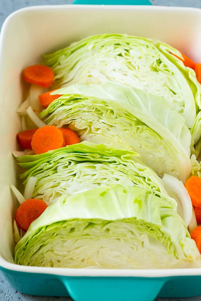 Braised Cabbage Recipe | Easy Cabbage Recipe #cabbage #lowcarb #keto #carrots #veggies #vegetarian #dinner #edsug Wedges of cabbage, sliced carrots and onion in a baking dish.