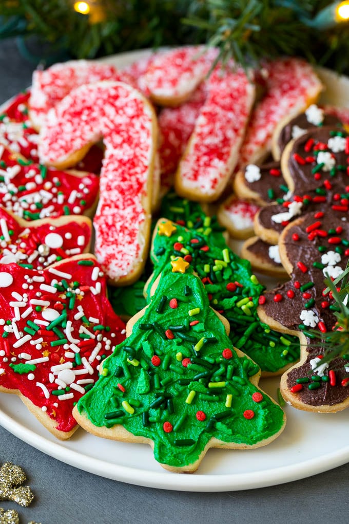 Christmas Sugar Cookies Recipe | Christmas Cookies #cookies #frosting #sprinkles #sugarcookies #christmas #dessert #edsug A serving plate of Christmas sugar cookies decorated with frosting and sprinkles.
