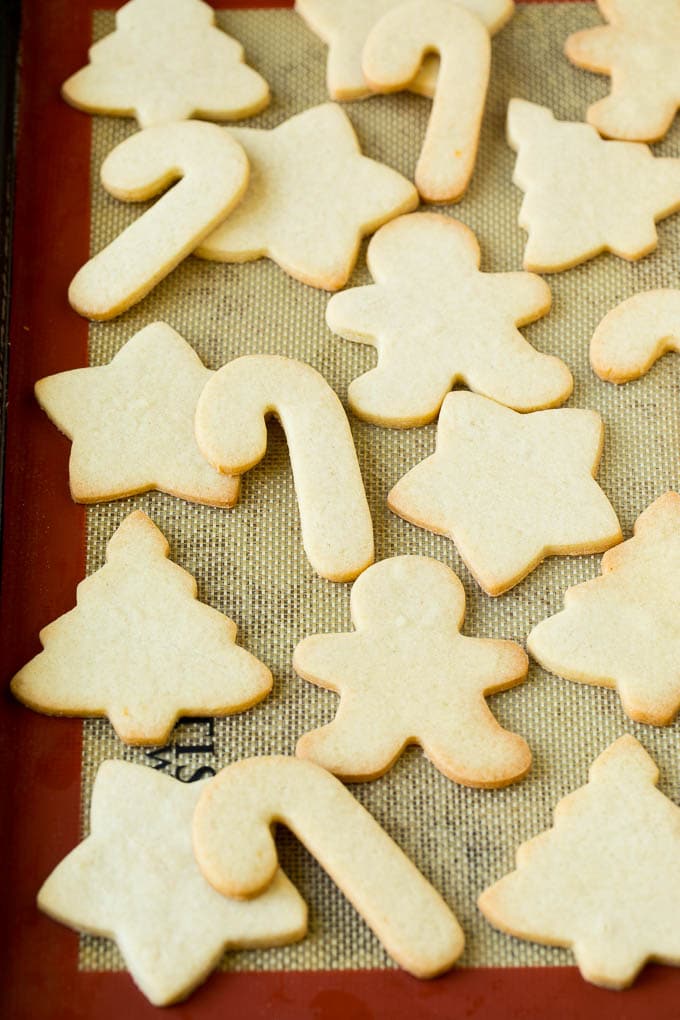 Christmas Sugar Cookies Recipe | Christmas Cookies #cookies #frosting #sprinkles #sugarcookies #christmas #dessert #edsug Cut out cookies on a sheet pan.