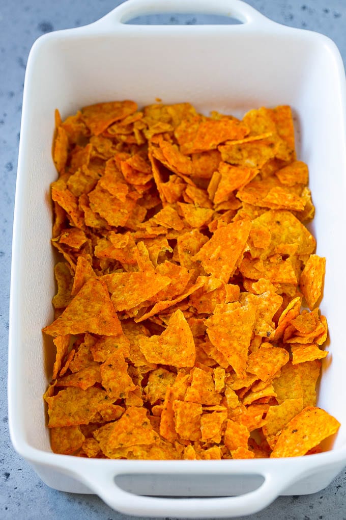 Dorito Casserole Recipe | Mexican Casserole | Beef Casserole #mexicanfood #beef #groundbeef #casserole #dinner #edsug Crushed nacho chips in the bottom of a casserole dish.