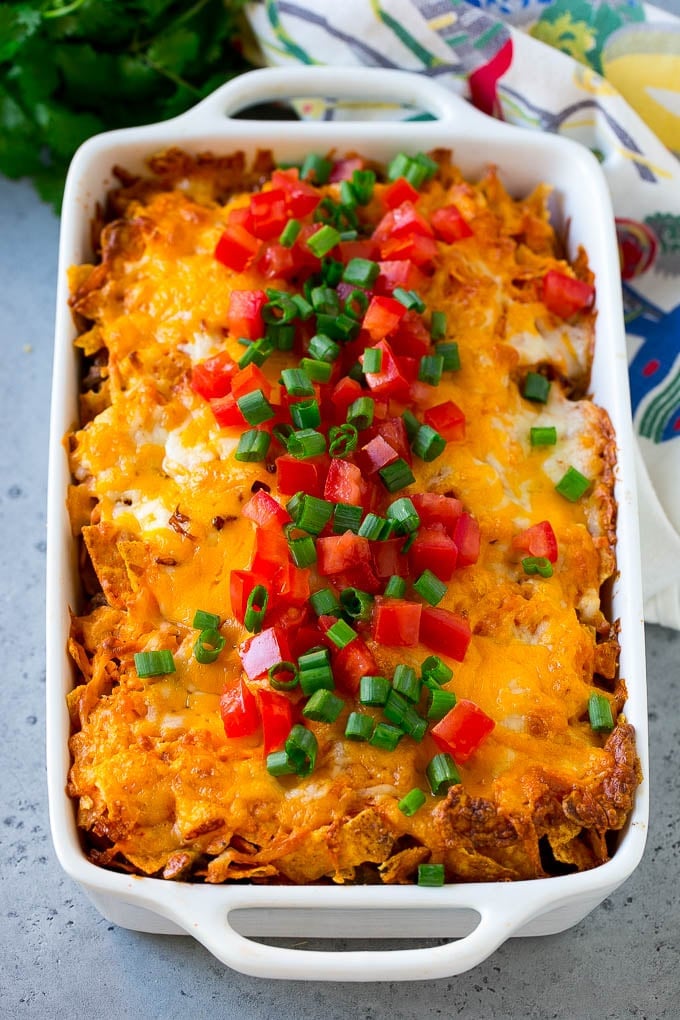 Dorito Casserole Recipe | Mexican Casserole | Beef Casserole #mexicanfood #beef #groundbeef #casserole #dinner #edsug Dorito casserole topped with melted cheese, diced tomatoes and sliced green onions.