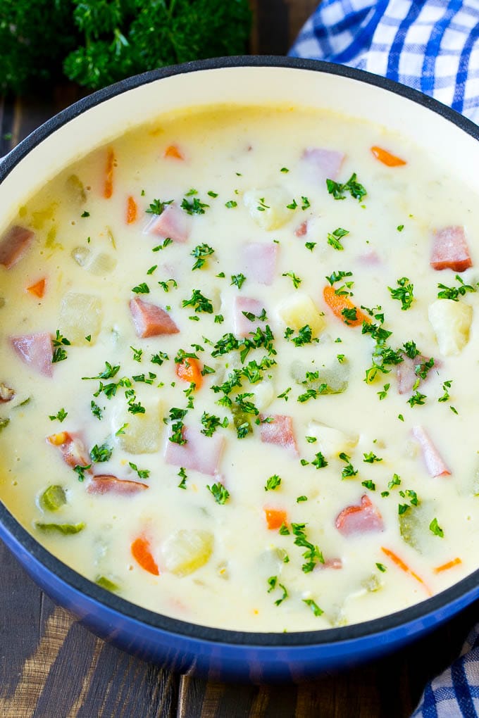 Ham and Potato Soup | Ham Soup | Potato Soup #soup #ham #potato #dinner #comfortfood #edsug A pot of ham and potato soup with vegetables in a creamy broth, topped with parsley.