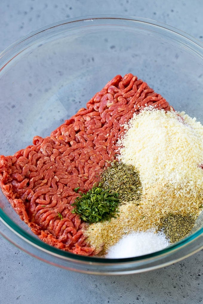 Italian Meatball Soup Recipe | Meatball Soup | Beef Meatballs #meatballs #beef #soup #italian #dinner #edsug #comfortfood Ground beef, breadcrumbs, parsley, herbs and parmesan cheese in a mixing bowl.
