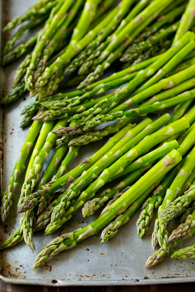 Roasted Asparagus Recipe | Baked Asparagus | Asparagus Side Dish #asparagus #garlic #sidedish #keto #lowcarb #dinner #edsug Raw asparagus spears on a sheet pan.