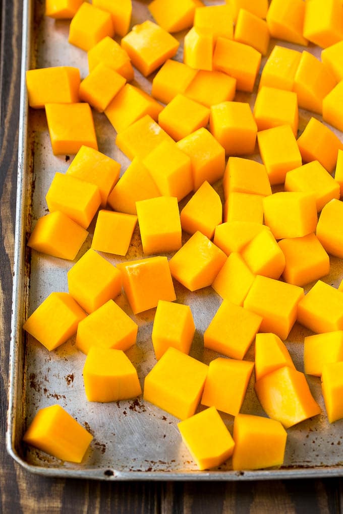 Roasted Butternut Squash Recipe | Baked Butternut Squash | Butternut Squash Side Dish #butternutsquash #squash #fall #vegetarian #dinner #edsug Raw cubed squash on a sheet pan.