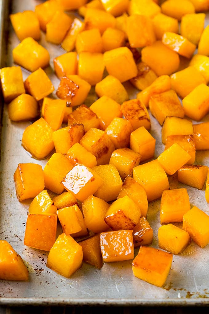 Roasted Butternut Squash Recipe | Baked Butternut Squash | Butternut Squash Side Dish #butternutsquash #squash #fall #vegetarian #dinner #edsug Caramelized cooked butternut squash on a sheet pan.