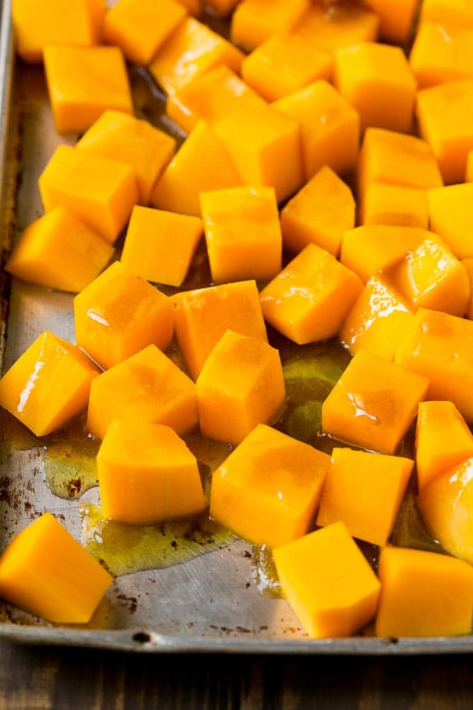 Roasted Butternut Squash Recipe | Baked Butternut Squash | Butternut Squash Side Dish #butternutsquash #squash #fall #vegetarian #dinner #edsug Cubes of winter squash coated in olive oil, brown sugar and maple syrup.