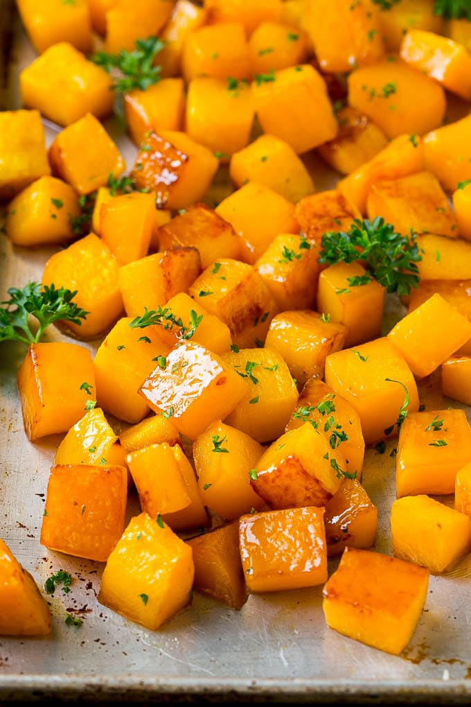 Roasted Butternut Squash Recipe | Baked Butternut Squash | Butternut Squash Side Dish #butternutsquash #squash #fall #vegetarian #dinner #edsug Roasted butternut squash with brown sugar and maple syrup, garnished with chopped parsley.