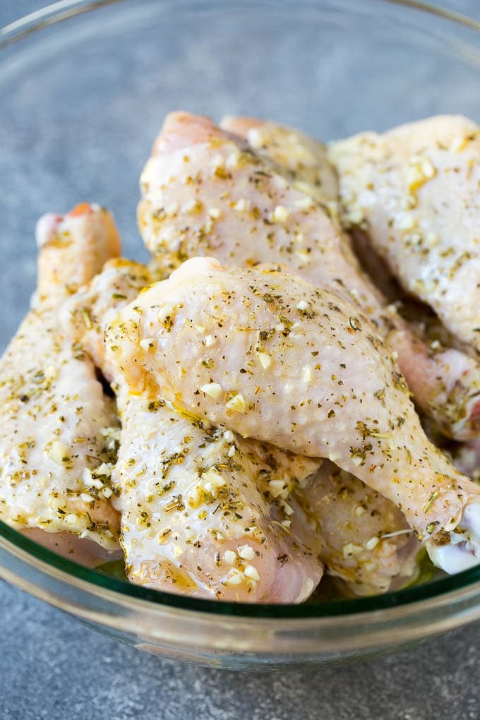 Baked Chicken Drumsticks Recipe | Roasted Chicken Drumsticks | Garlic and Herb Chicken #dinner #chicken #garlic #glutenfree #lowcarb #keto #cleaneating #edsug A bowl of chicken legs in a garlic and herb marinade.