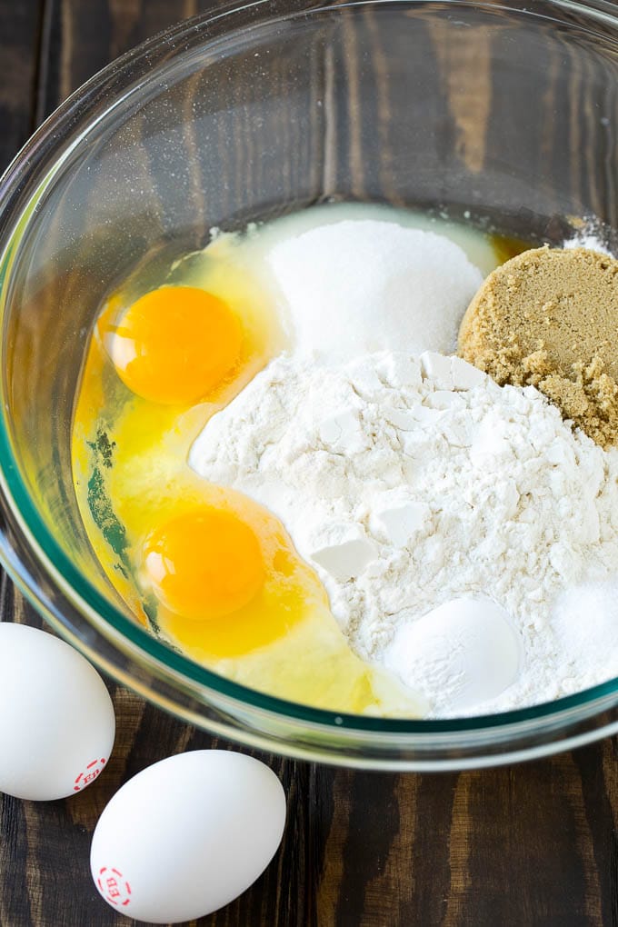 Baked Donuts Recipe | Cake Donuts | Chocolate Donuts | Sprinkle Donuts #donuts #chocolate #sprinkles #breakfast #brunch #edsug Flour, sugar, baking powder and eggs in a mixing bowl.