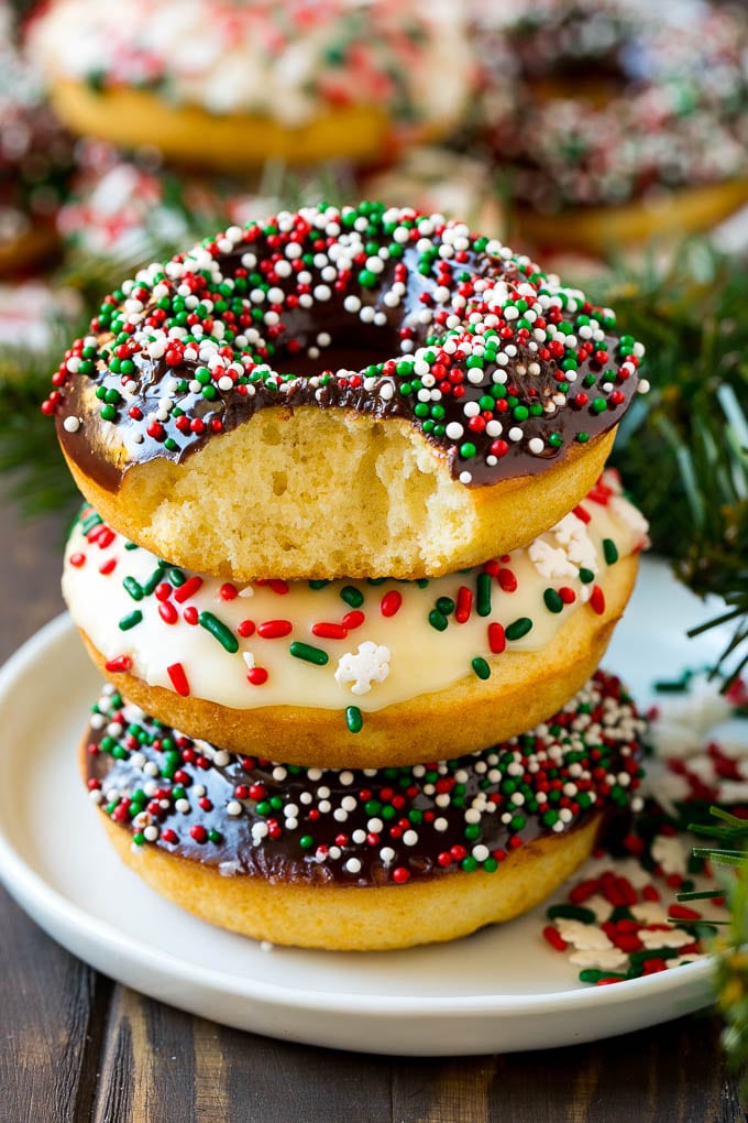 Baked Donuts Recipe | Cake Donuts | Chocolate Donuts | Sprinkle Donuts #donuts #chocolate #sprinkles #breakfast #brunch #edsug A stack of donuts with a bite out of one.