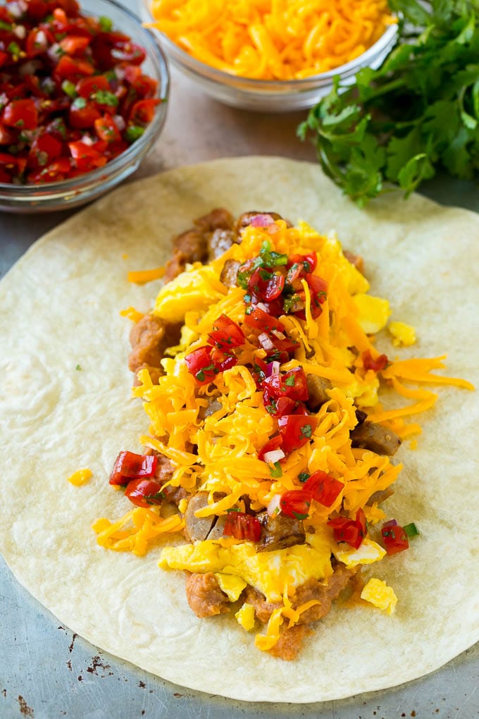 Breakfast Burrito Recipe | Sausage Breakfast Burrito #breakfast #sausage #eggs #burrito #edsug A flour tortilla topped with eggs, sausage, cheese and pico de gallo salsa.