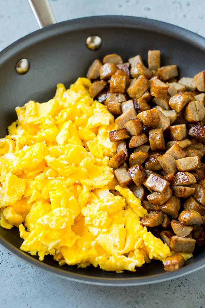 Breakfast Burrito Recipe | Sausage Breakfast Burrito #breakfast #sausage #eggs #burrito #edsug Diced sausage and scrambled eggs in a pan.