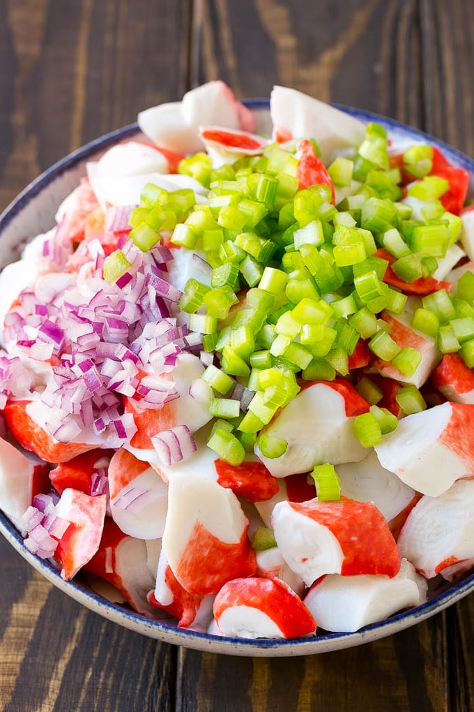 Crab Salad Recipe | Seafood Salad | Deli Salad #crab #salad #seafood #lowcarb #keto #lunch #dinner #edsug Imitation crab, celery and red onion in a serving bowl.