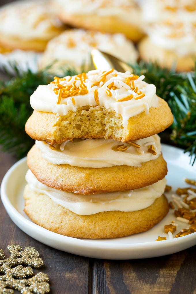 Eggnog Cookies Recipe | Holiday Cookies | Christmas Cookies #cookies #eggnog #baking #christmas #sprinkles #dessert #edsug A stack of eggnog cookies with a bite taken out of one.