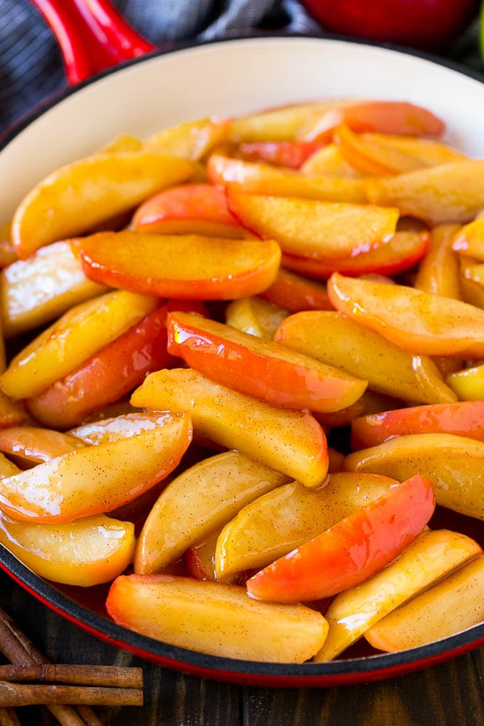 Fried Apples Recipe | Sauteed Apples | Cinnamon Sugar Apples #apples #cinnamon #sugar #sidedish #dessert #edsug #fall Southern fried apples coated in butter, cinnamon and sugar in a red skillet.