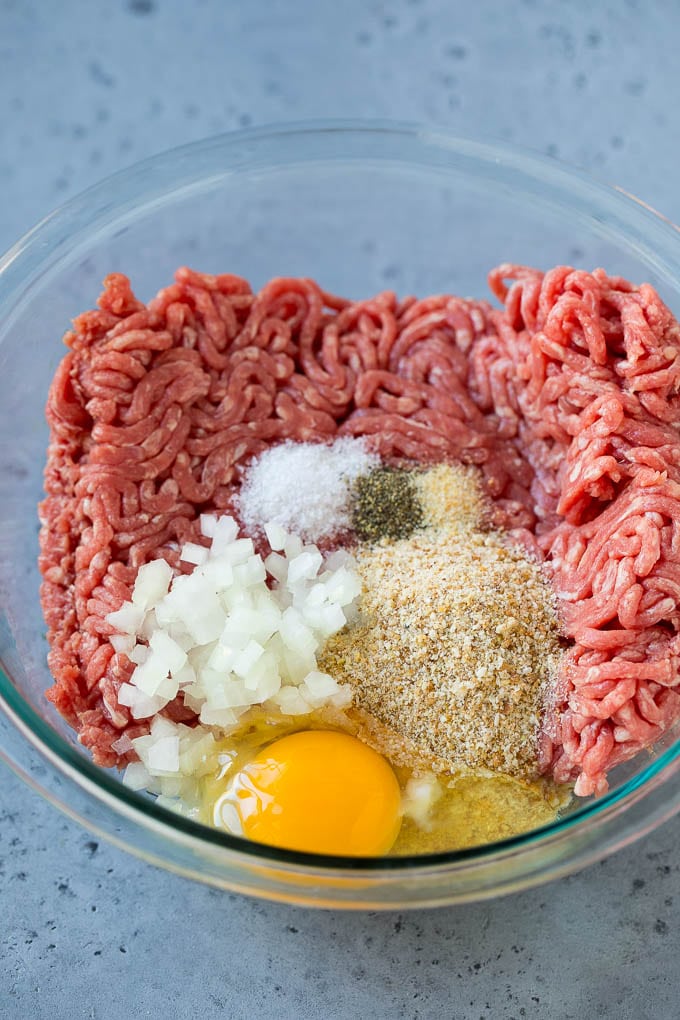 Sweet and Sour Meatballs Recipe | Slow Cooker Meatballs | Crockpot Meatballs | Cocktail Meatballs #meatballs #beef #slowcooker #crockpot #dinner #appetizer #edsug Ground beef, onion, breadcrumbs and seasonings in a bowl.
