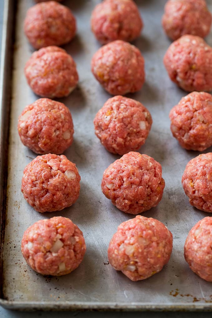 Sweet and Sour Meatballs Recipe | Slow Cooker Meatballs | Crockpot Meatballs | Cocktail Meatballs #meatballs #beef #slowcooker #crockpot #dinner #appetizer #edsug Homemade meatballs on a sheet pan.