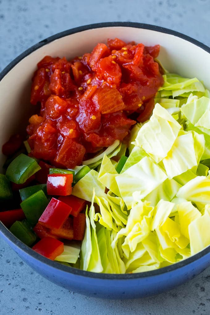 Cabbage Soup Recipe | Vegetable Soup | Veggie Soup | Healthy Soup #soup #healthy #cleaneating #cabbage #vegetables #veggies #dinner #edsug Red and green peppers, diced tomatoes and raw veggies in a large pot.