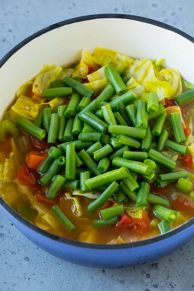 Cabbage Soup Recipe | Vegetable Soup | Veggie Soup | Healthy Soup #soup #healthy #cleaneating #cabbage #vegetables #veggies #dinner #edsug Green beans in a pot of cooked veggies.