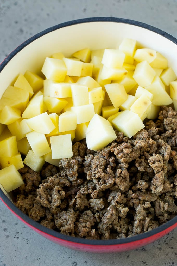 Cheeseburger Soup Recipe | Hamburger Soup | Cheese Soup #soup #groundbeef #hamburger #cheese #bacon #dinner #edsug Cooked ground beef and potatoes in a pot.