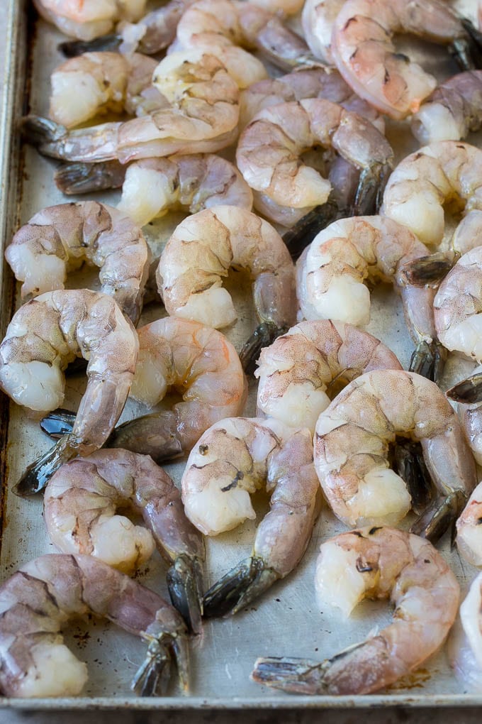 Coconut Shrimp Recipe | Fried Shrimp | Shrimp Appetizer #shrimp #coconut #appetizer #seafood #dinner #edsug Large raw tail-on shrimp arranged on a sheet pan.