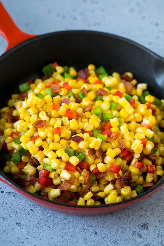 Corn Dip Recipe | Hot Cheese Dip | Bacon Dip #corn #dip #bacon #cheese #appetizer #snack #edsug Corn, bacon and bell peppers in a skillet.