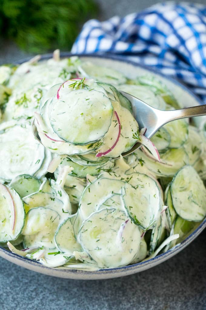 Creamy Cucumber Salad Recipe | German Cucumber Salad | Cucumber Salad #cucumber #salad #dinner #lunch #edsug #cucumbersalad A spoon serving up a portion of creamy cucumber salad.