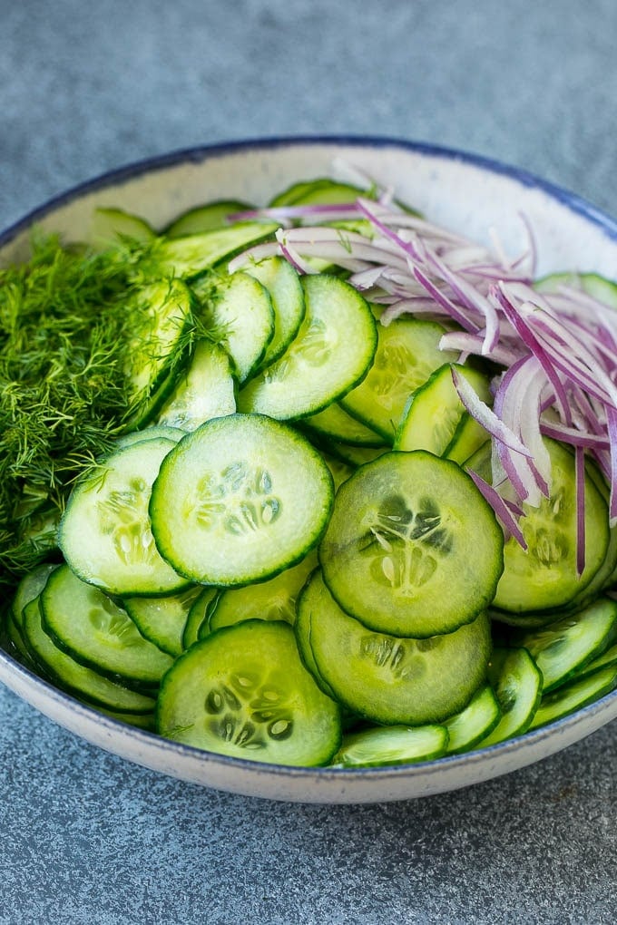 Cucumber Salad Recipe | Cucumber Dill Salad | Cucumber Recipe #cucumbers #salad #glutenfree #sidedish #edsug Ingredients including red onion and dill in a bowl.