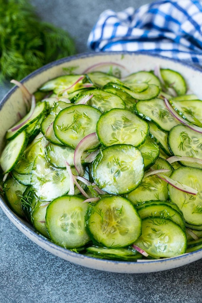 Cucumber Salad Recipe | Cucumber Dill Salad | Cucumber Recipe #cucumbers #salad #glutenfree #sidedish #edsug A bowl of cucumber salad with red onion, thinly sliced cucumbers and chopped dill.