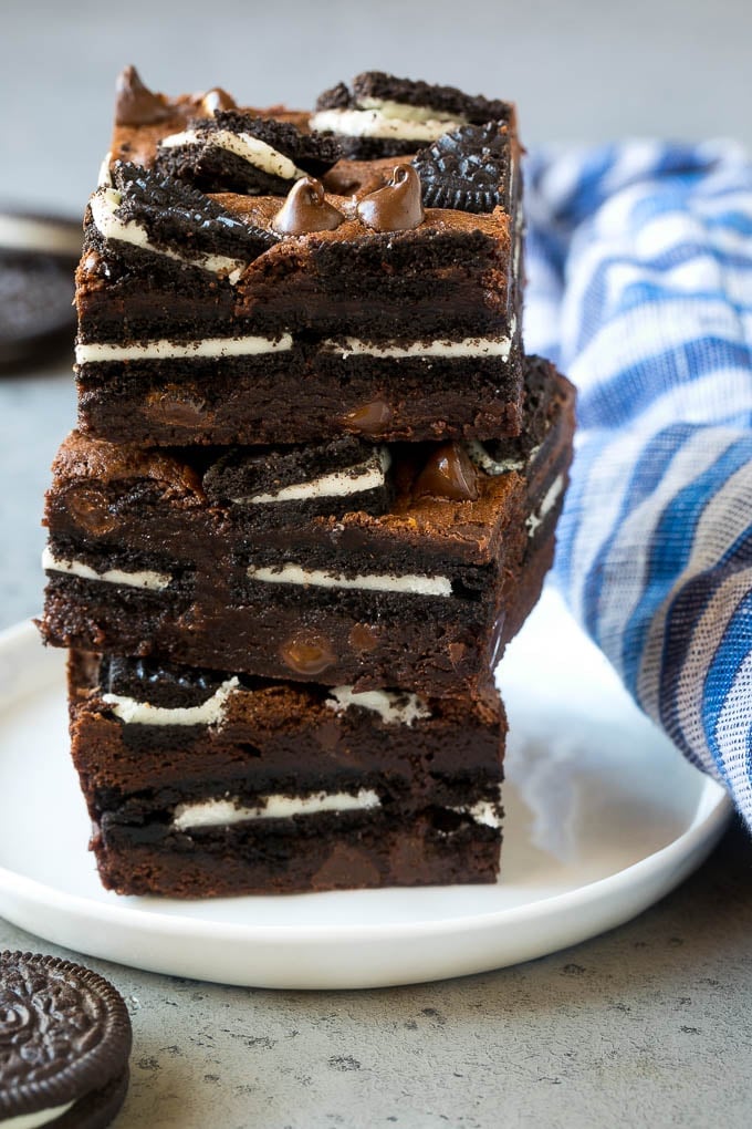 Oreo Brownies Recipe | Homemade Brownies | Chocolate Chip Brownies #brownies #oreos #chocolate #dessert #sweets #edsug A stack of Oreo brownies filled with sandwich cookies and chocolate chips.