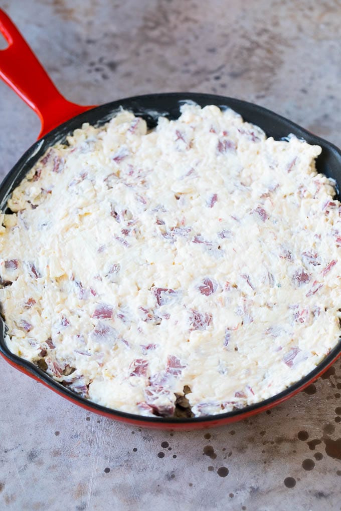 Reuben Dip Recipe | Corned Beef Dip | Cheese Dip #dip #cheese #cornedbeef #appetizer #lowcarb #keto #edsug Cream cheese, corned beef and other ingredients spread into a skillet for baking.