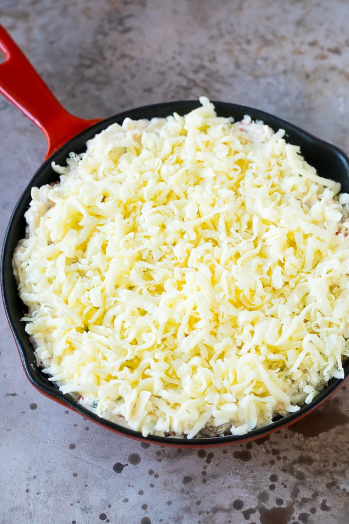 Reuben Dip Recipe | Corned Beef Dip | Cheese Dip #dip #cheese #cornedbeef #appetizer #lowcarb #keto #edsug A skillet of dip topped with shredded cheese.