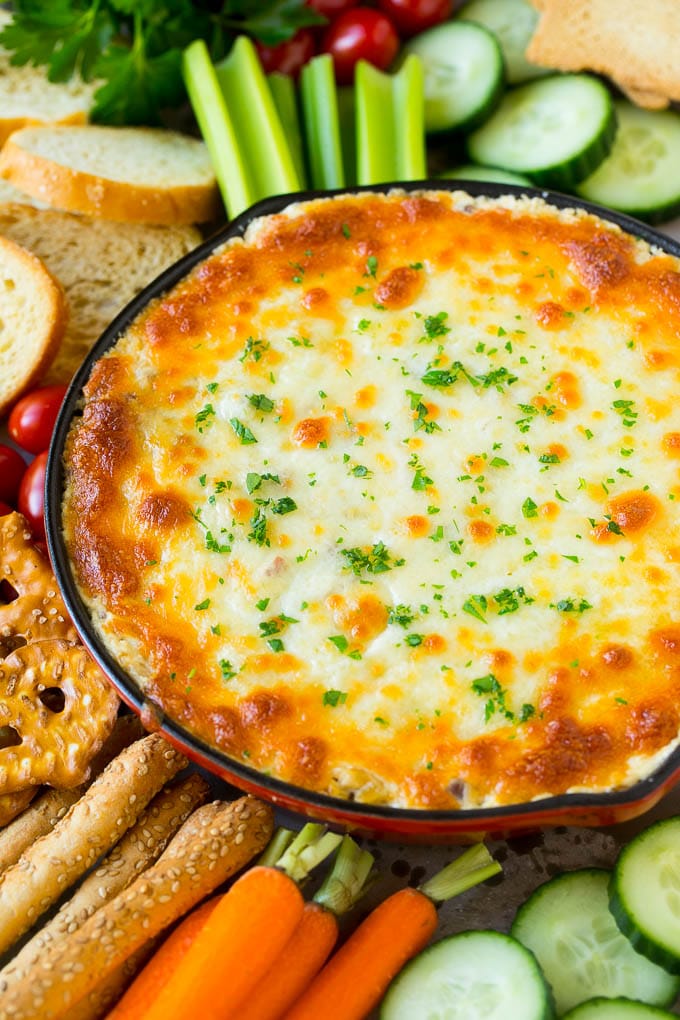 Reuben Dip Recipe | Corned Beef Dip | Cheese Dip #dip #cheese #cornedbeef #appetizer #lowcarb #keto #edsug Baked Reuben dip in a skillet served with crackers and vegetables.