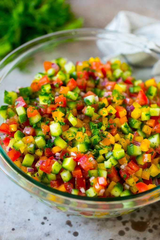 Israeli Salad Recipe | Cucumber Salad | Tomato Salad | Chopped Salad #salad #cleaneating #healthy #glutenfree #lowcarb #keto #sidedish #lunch #edsug Israeli salad with cucumbers and tomatoes in a serving bowl.
