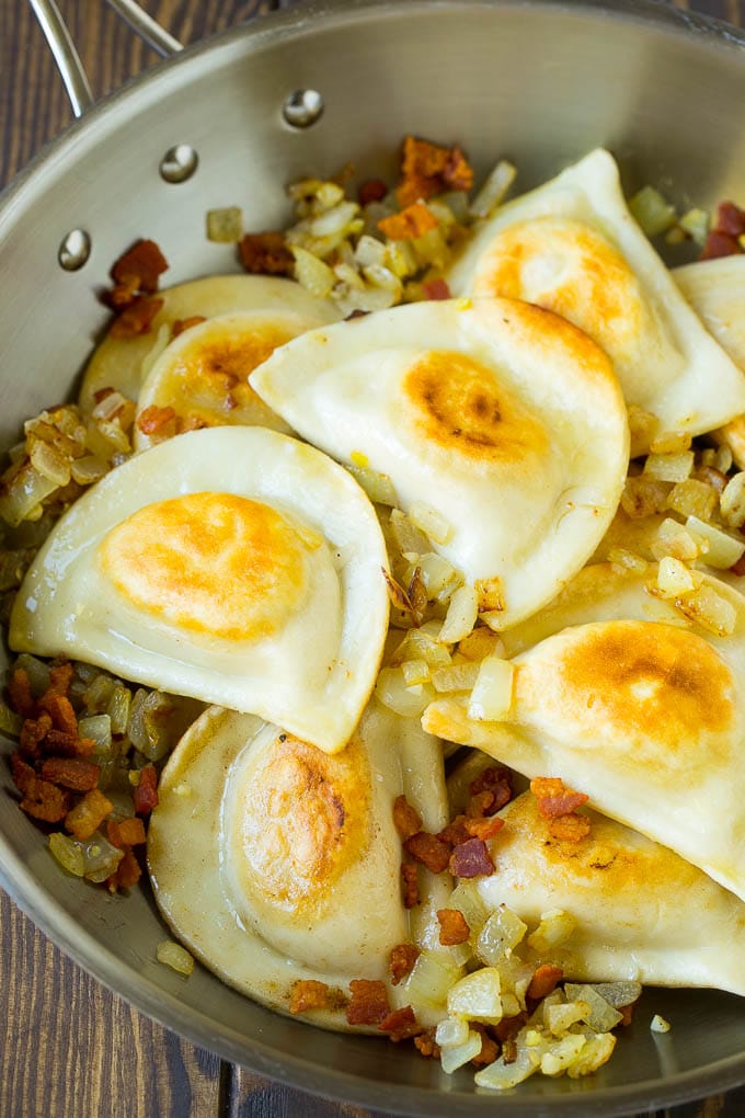 Pierogi Casserole Recipe | Potato Casserole #pierogis #casserole #bacon #cheddar #dinner #edsug Sauteed pierogis with bacon and onions in a skillet.