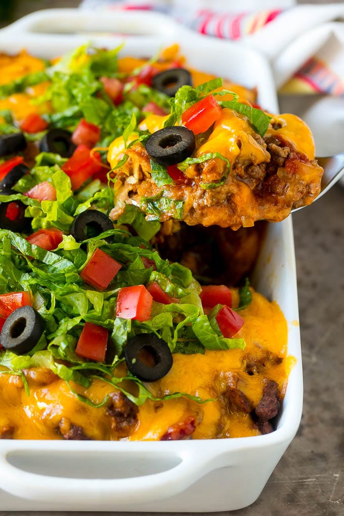 Taco Casserole Recipe | Mexican Casserole | Beef Casserole #casserole #tacos #beef #dinner #cheese #edsug A spoon serving up a portion of beef taco casserole.