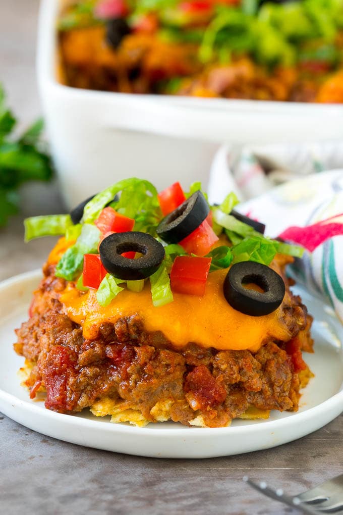 Taco Casserole Recipe | Mexican Casserole | Beef Casserole #casserole #tacos #beef #dinner #cheese #edsug A serving of taco casserole topped with melted cheese.