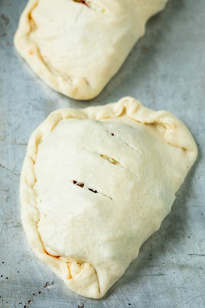 Calzone Recipe | Pizza Pockets #pizza #calzone #pepperoni #sausage #peppers #dinner #edsug #cheese Unbaked calzones ready to go into the oven.