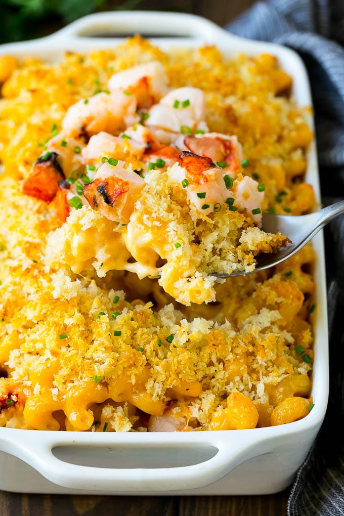 Lobster Mac and Cheese Recipe | Lobster Macaroni and Cheese | Baked Mac and Cheese #pasta #macandcheese #macaroni #lobster #cheese #dinner #edsug A spoon serving up a portion of lobster mac and cheese.