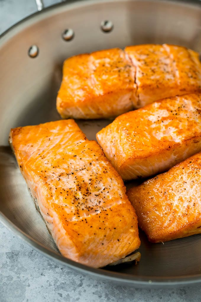 Pan Seared Salmon Recipe | Garlic Butter Salmon | Seared Salmon #salmon #garlic #butter #keto #lowcarb #dinner #edsug Sauteed salmon fillets in a metal skillet.