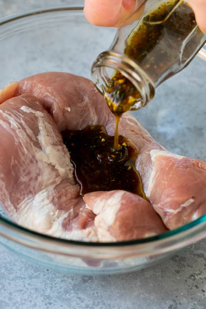 Marinated Pork Tenderloin Recipe | Pork Tenderloin Marinade | Pork Marinade #pork #porktenderloin #marinade #dinner #grilling #edsug Marinade being poured over pork tenderloin.