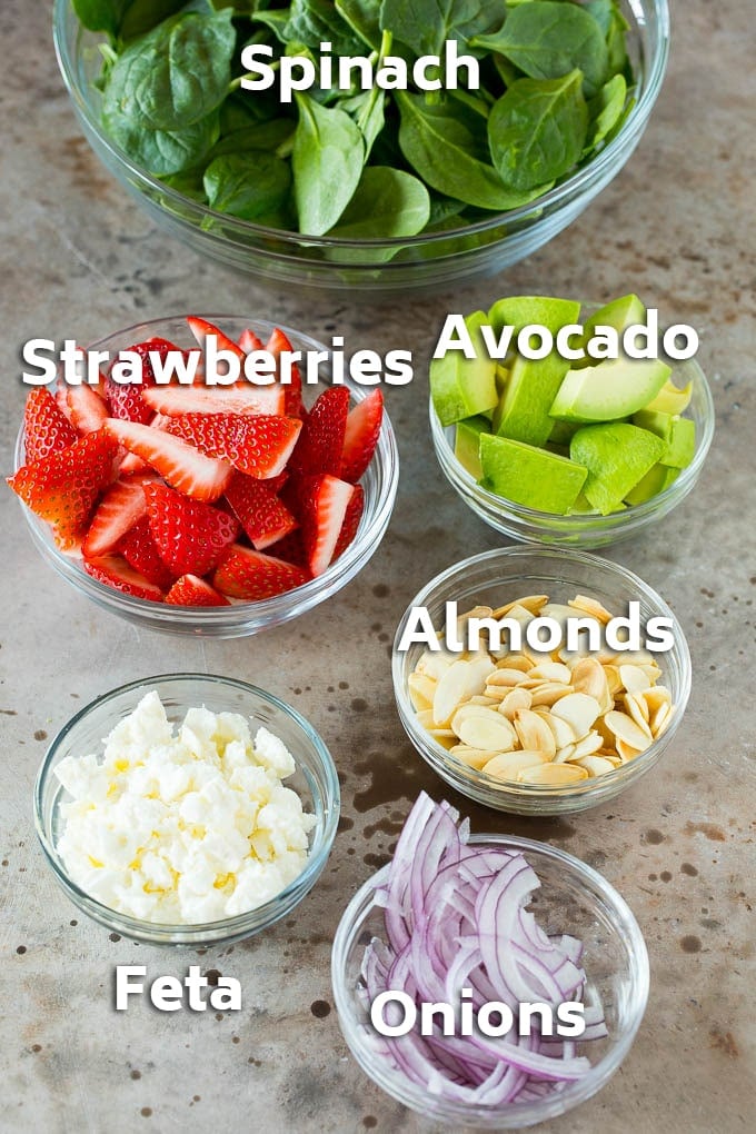 Strawberry Spinach Salad Recipe | Strawberry Salad | Spinach Salad #spinach #salad #strawberries #avocado #edsug Bowls of ingredients like feta cheese, almonds, red onion and avocado.
