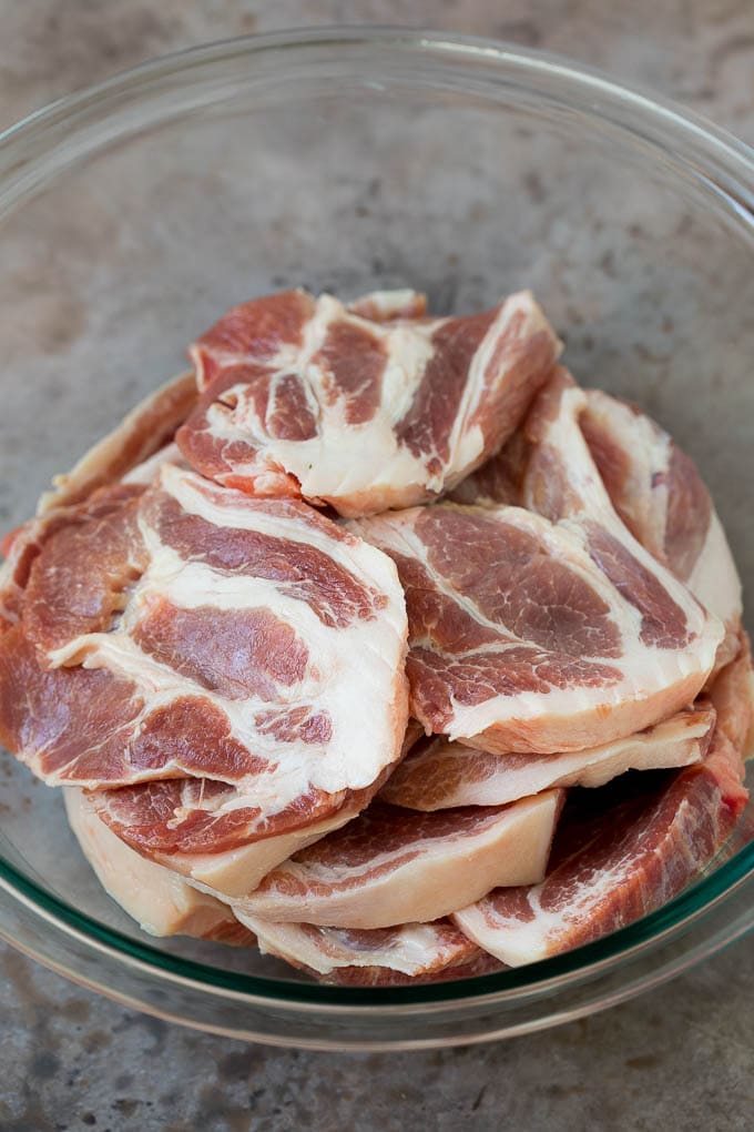 Tacos al Pastor Recipe | Pork Tacos | Mexican Tacos #tacos #pork #pineapple #grilling #tacotuesday #dinner #edsug Sliced pork shoulder in a bowl.